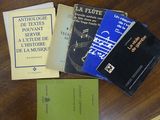 several books on a table that are sitting on top of a wooden table