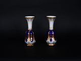 pair of blue and white vases on a black background