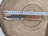 a knife that is sitting on top of a piece of wood