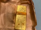 a piece of gold on a piece of brown paper