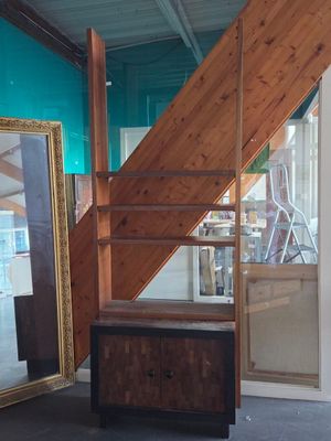 a picture of a room with a staircase and a mirror on the wall