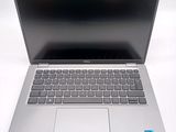an open laptop computer sitting on top of a white table