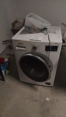 a washer and a dryer in a dirty room