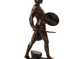 bronze statue of a man holding a shield and shield in his hand