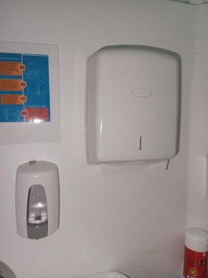 des toilettes équipées d'un distributeur de papier essuie-mains fixé au mur