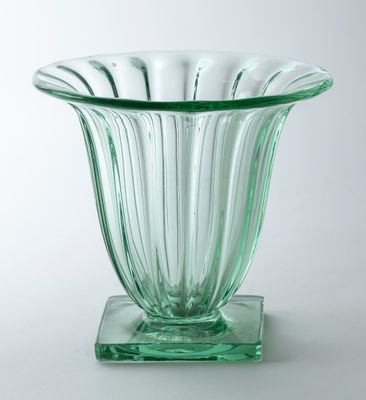 a glass vase that is sitting on a stand