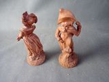 two figurines of a man and a woman on a table