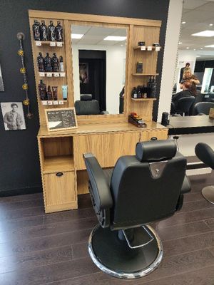 an image of a hair salon with chairs and a mirror