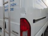 a white van that has a ladder on the back of it