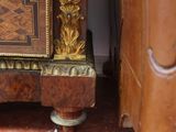a wooden cabinet that has a clock on top of it