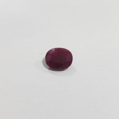 a red ruby gems on a white surface