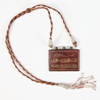an image of a brown and red book with a tassel on a white background