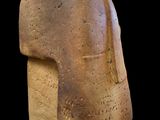 statue of a man ' s head made of clay on a black background