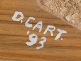 a close up of a wooden sign on a table