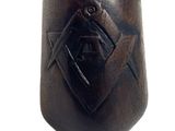 an image of a wooden mask with a masonic symbol on it
