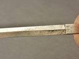 a knife that has been cut in half and is being held by a pair of scissors