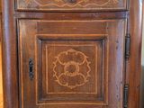 a wooden cabinet with a door and a drawer on top of it
