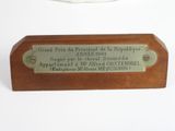 wooden plaque with a plaque on it stating the name of a person who died in the french revolution