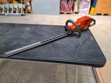 a chainsaw sitting on a table in a warehouse