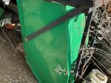 a green door sitting in the middle of a pile of junk