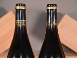 two bottles of wine that are sitting on a table