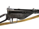 an old machine gun with a sling attached to it ' s side