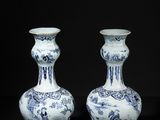 pair of blue and white vases on a black background