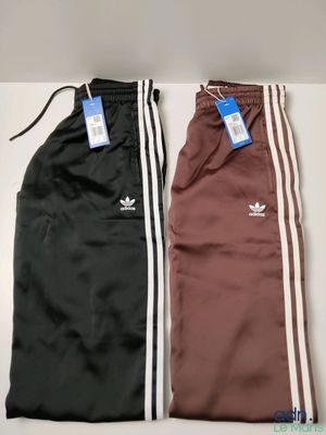 two pairs of adidas track pants with tags on them