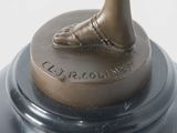a bronze statue of a woman ' s foot on a pedestal