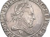 a close up of a coin with a man ' s face on it