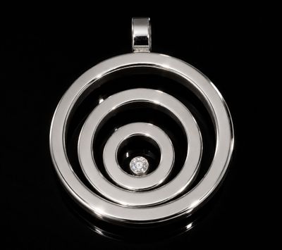 a black and white photo of a pendant with a diamond in it