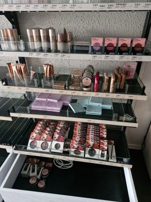 a lot of makeup products on the shelves in the store