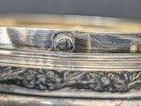 a close up of a silver plate with a lion on it
