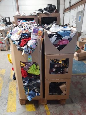 a carton full of clothes and other items in a warehouse