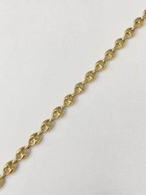 a close up of a gold chain on a white surface
