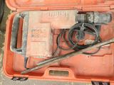 an orange case with tools in it sitting on the floor