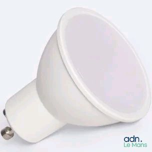 a close up of a white light bulb on a white surface