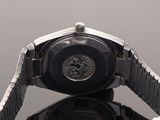a close up of a watch on a black surface