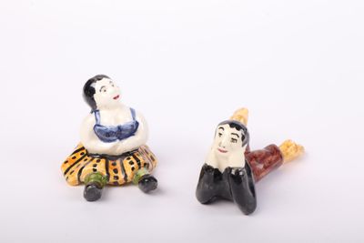 two figurines of a woman and a man sitting next to each other
