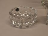 a small glass bowl and a small glass vase on a table