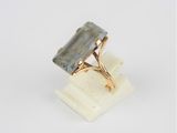 an image of a gold ring with a green tourmaline stone on it