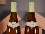 two bottles of wine that are sitting on a table