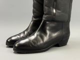 black leather cowboy boots with buckles on the side of them