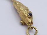 a gold bird with a ring in it ' s mouth