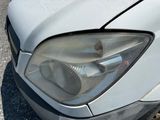 a close up of a car ' s headlight on the street