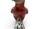 a figurine of a parrot on a white background