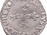 a close up of a coin with a cross on it