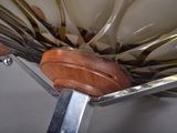 spoons and spoon rest on a metal stand with a wooden handle