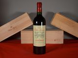 a bottle of wine sitting on a table next to two wooden boxes