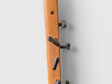 a wooden coat rack that has a bunch of screws on it